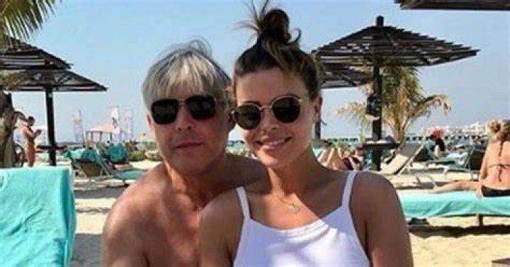 Chloe Lewis defends bikini picture with her dad's hand on her leg 'It