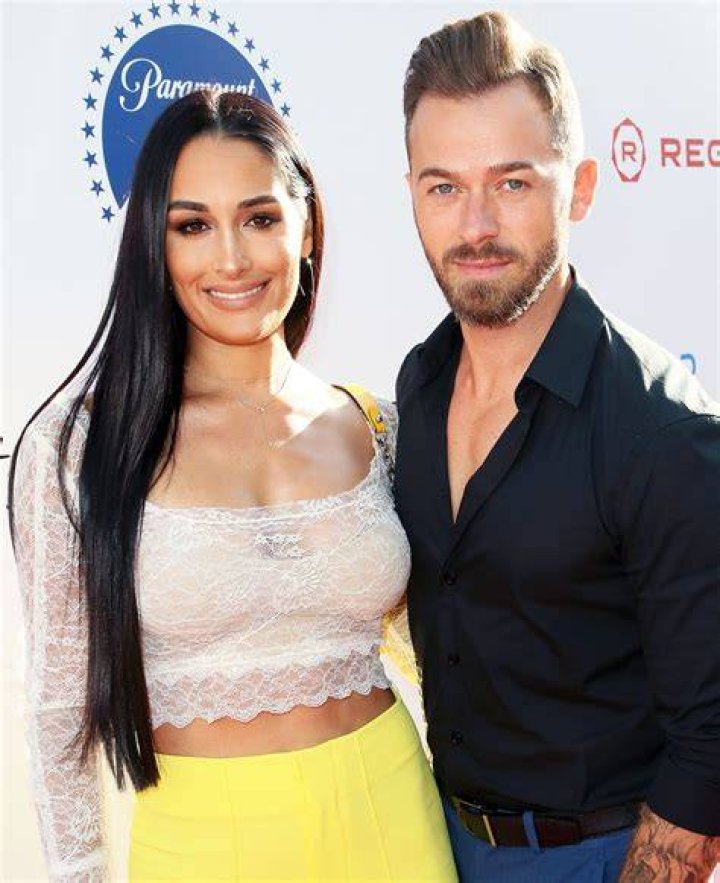Nikki Bella and boyfriend Artem Chigvintsev pack on some PDA while out