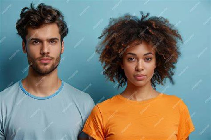 two people standing next to each other in front of a mirror with their